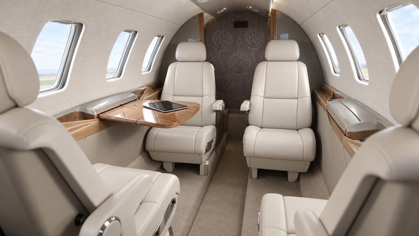 Citation M2 cabin looking aft, four club seats in light leather with fold out tables