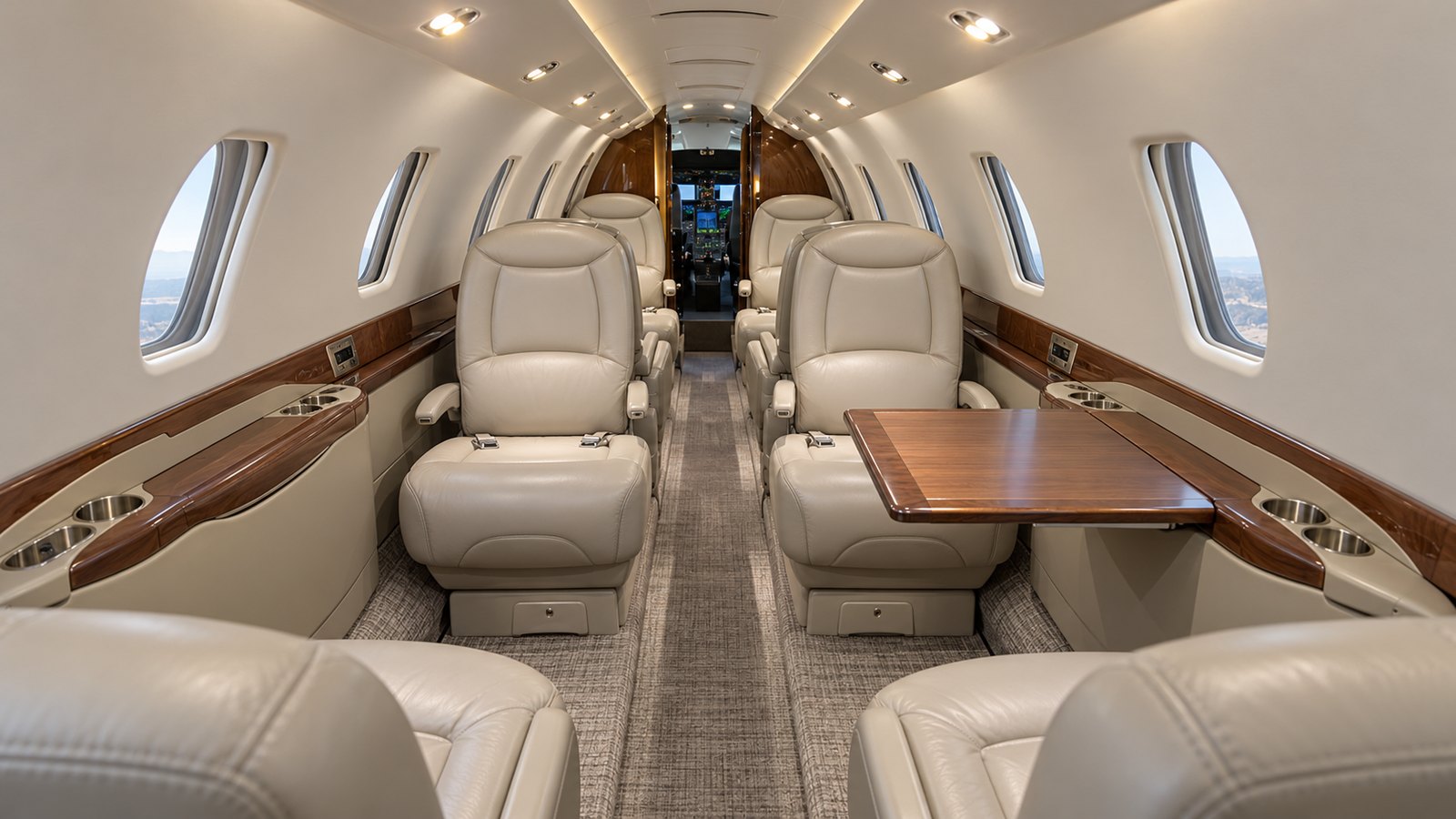 Citation Sovereign cabin looking toward the cockpit, double club seating in cream leather