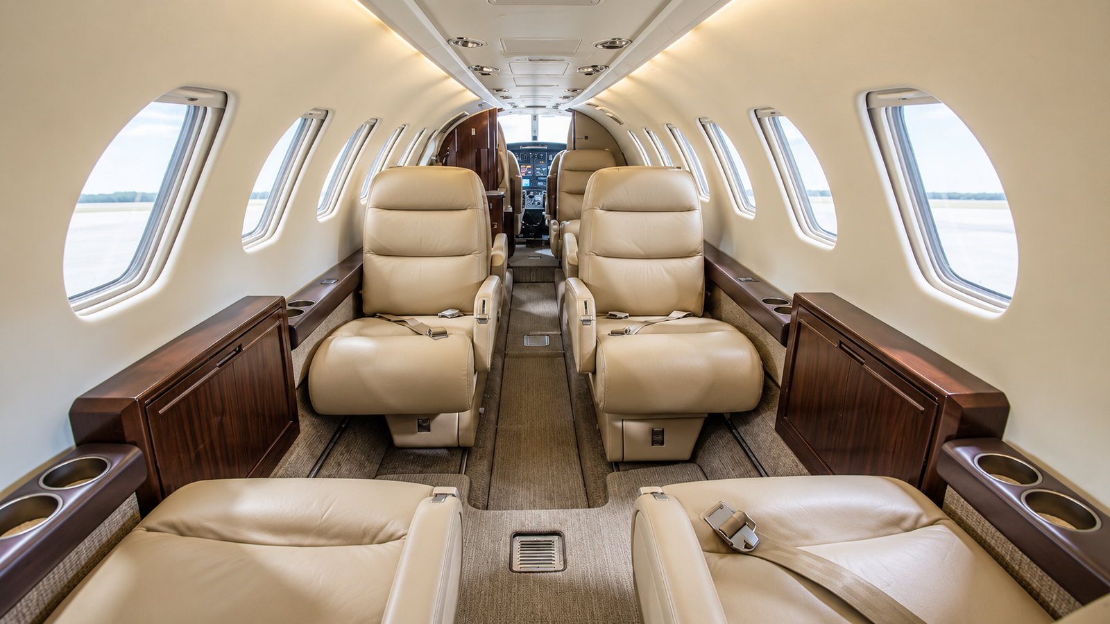 Citation V cabin looking forward, club seats in cream leather with dark wood trim