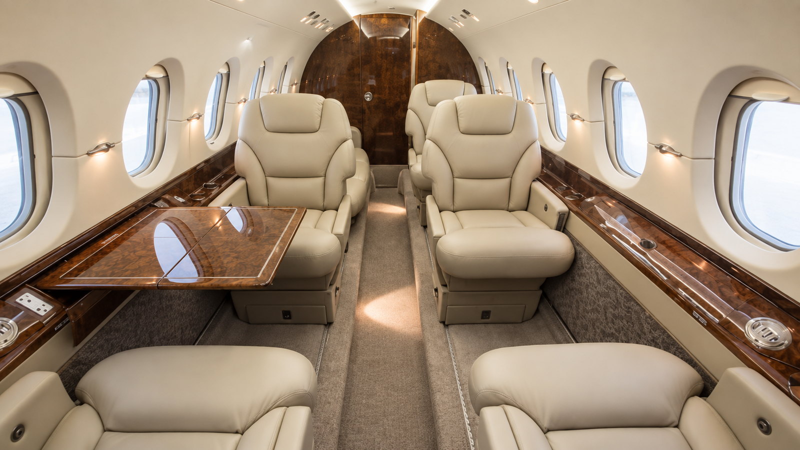 Hawker 800XP cabin looking aft, club seats with tables and a divan