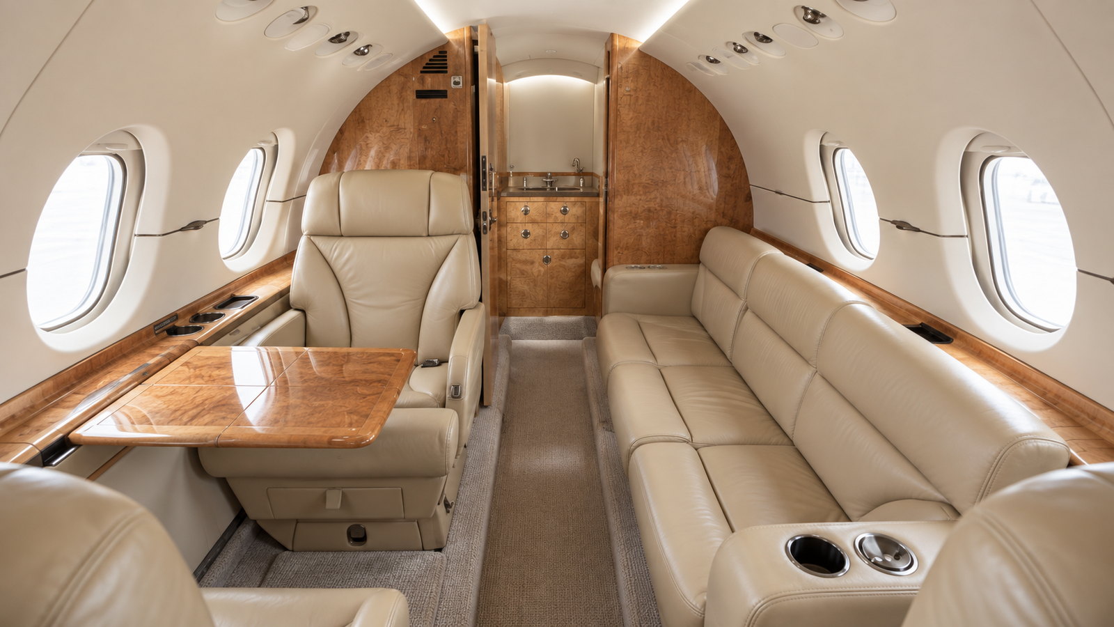Hawker 900XP cabin looking aft, club seats and a divan with a fold out table