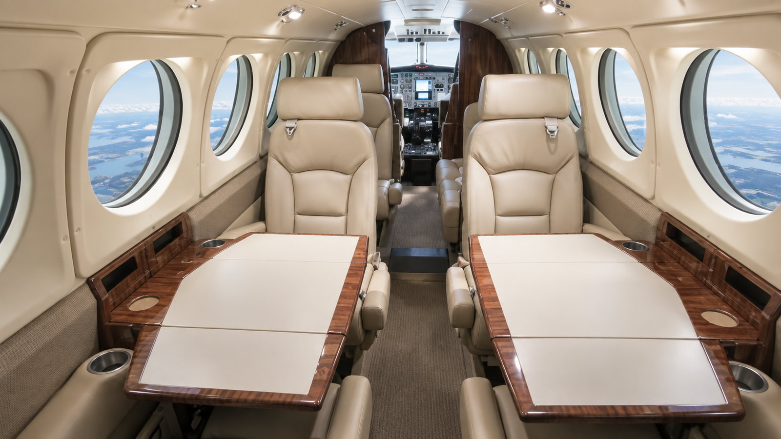 King Air 200 cabin looking forward, four club seats around two tables