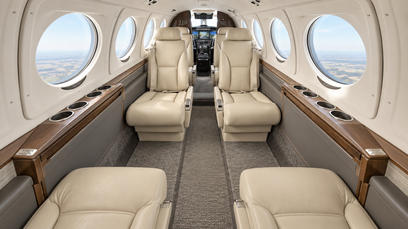 King Air 260 cabin looking forward, club seats in cream leather with an aisle between them