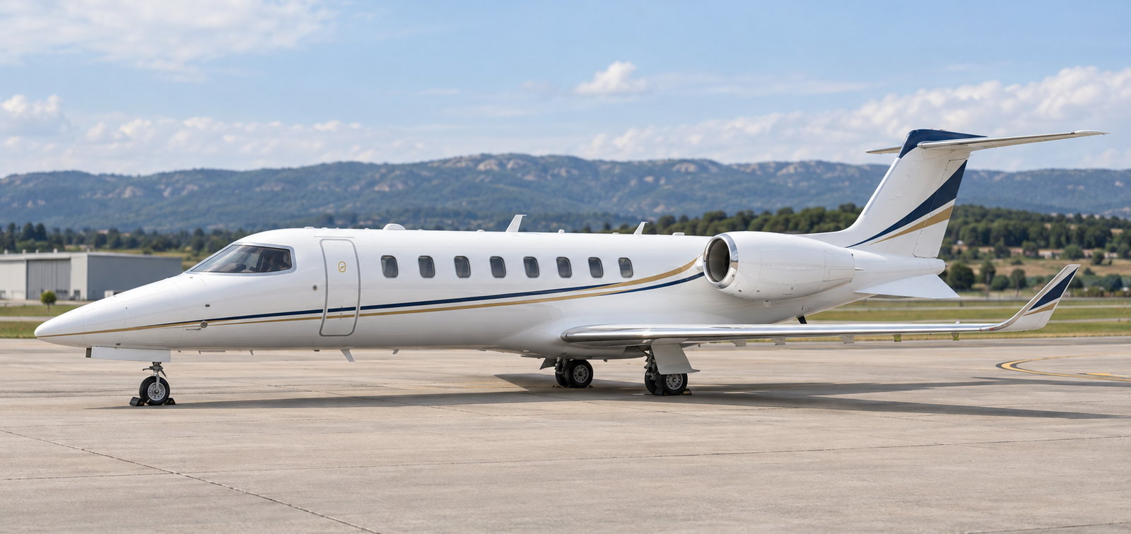 Bombardier Learjet 75 on an apron with hills behind