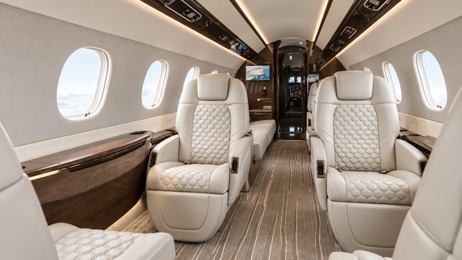 Legacy 450 cabin looking forward, quilted club seats and a wood floor