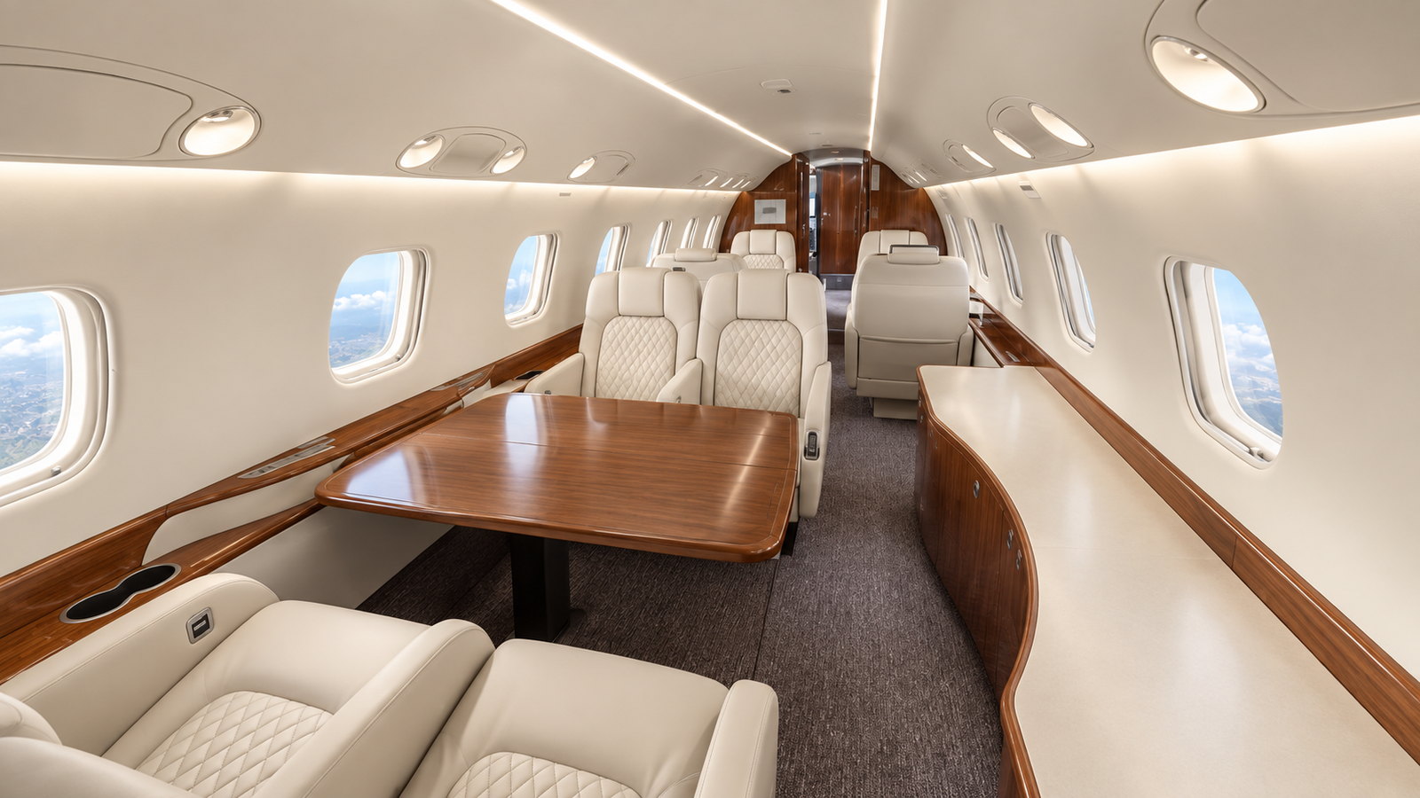 Legacy 600 cabin looking forward, club seats and a table in a long cabin