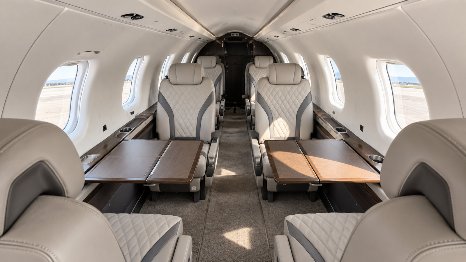 Pilatus PC-12 NGX cabin looking aft, club seats in quilted leather with a table