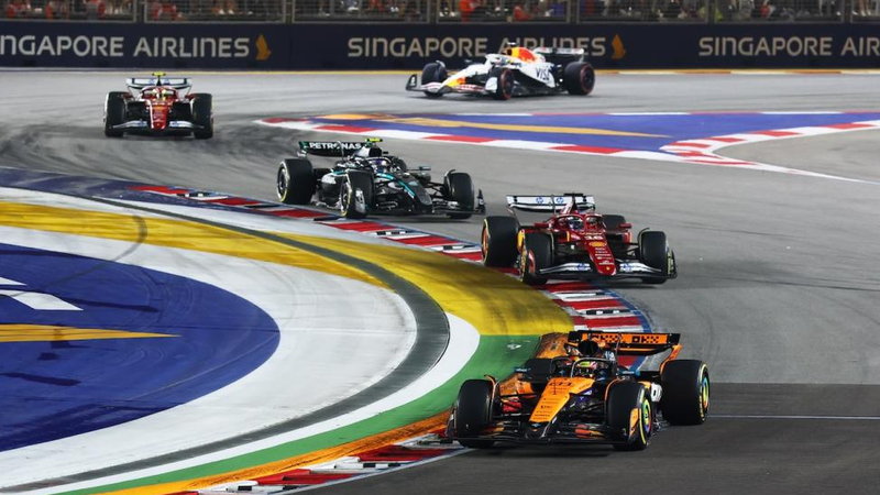 Formula 1 cars on the Marina Bay street circuit in Singapore at night