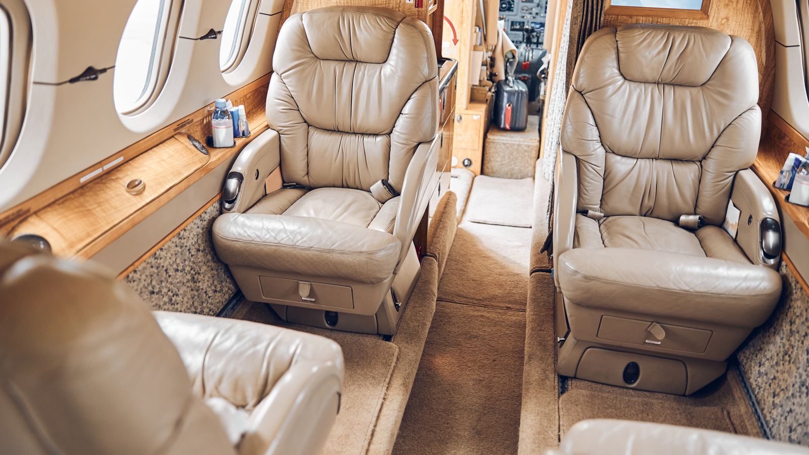 Leather seats facing each other in the cabin of a light business jet