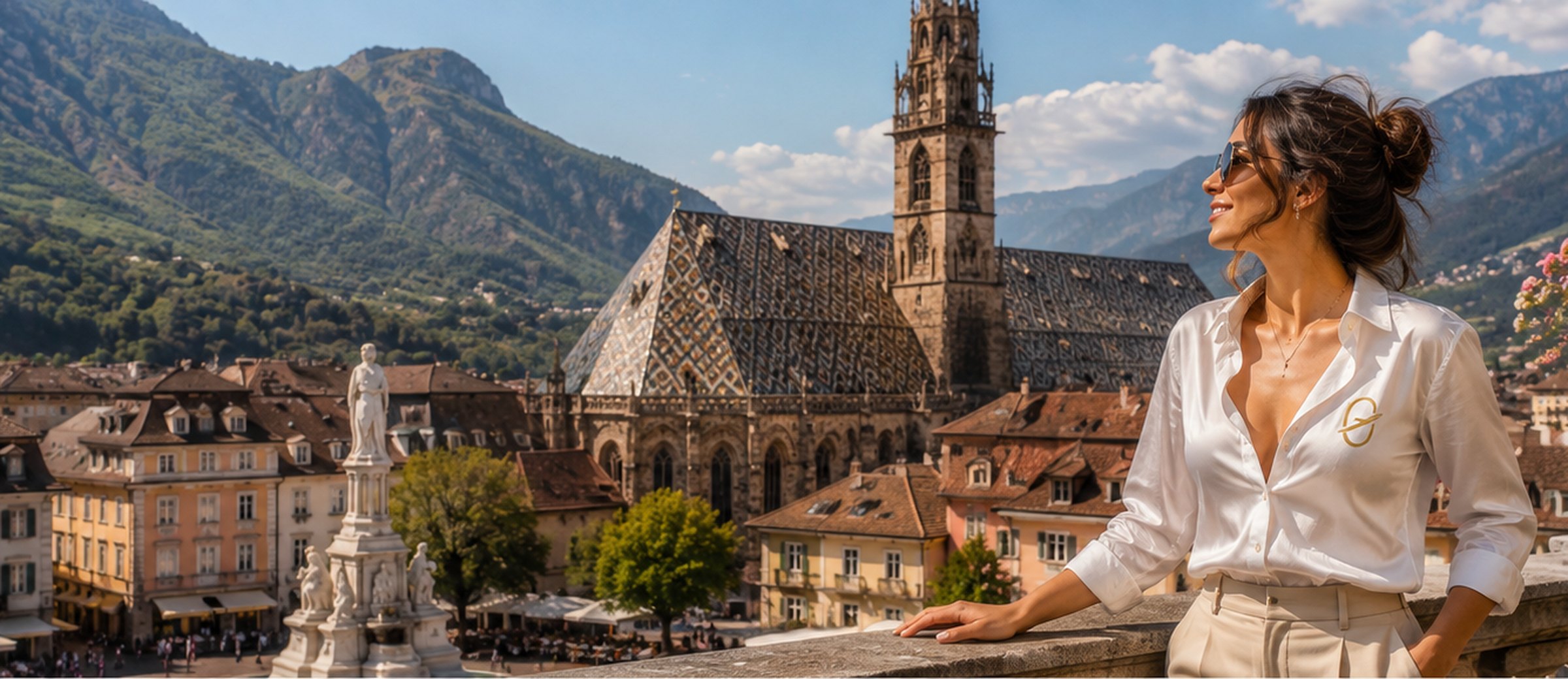 Piazza Walther in Bolzano, the patterned roof and tower of the cathedral, and the mountains behind the town