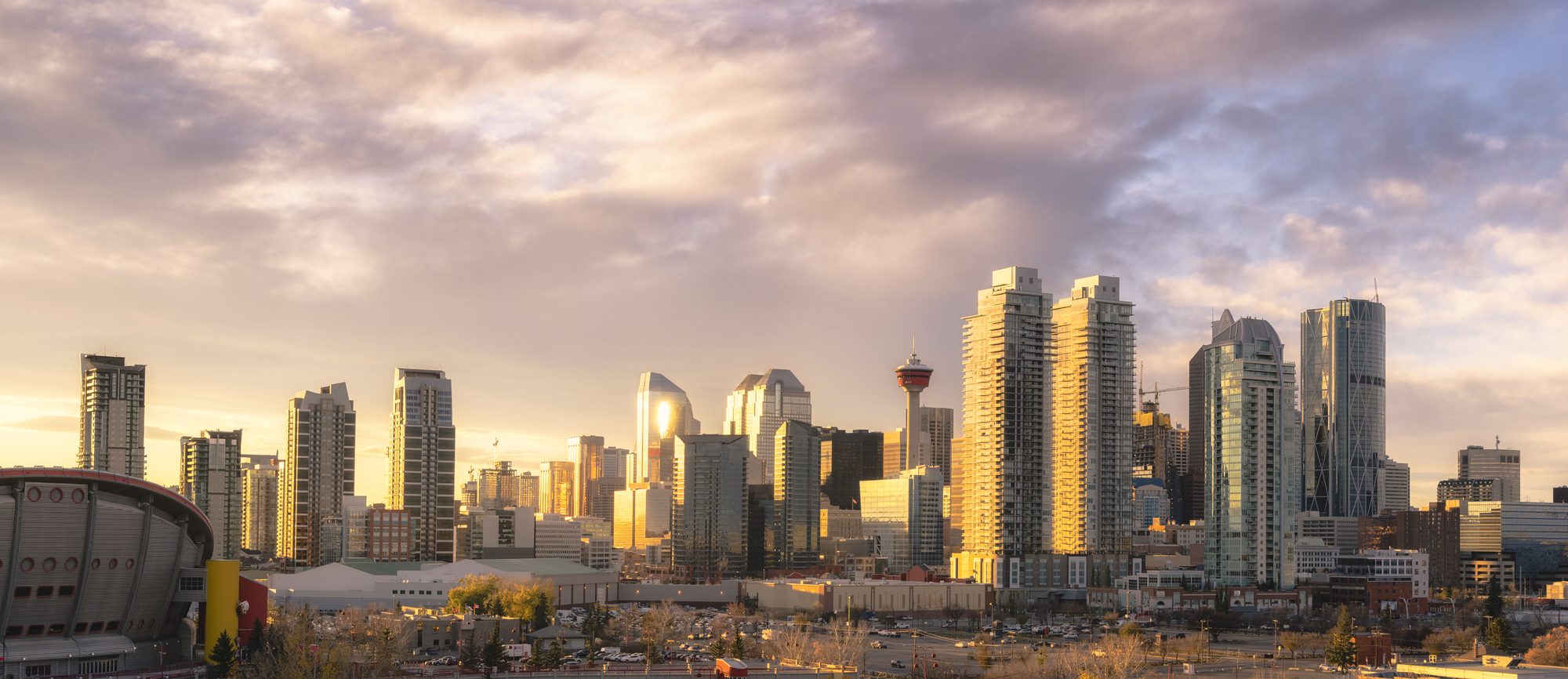 Downtown Calgary lit by the sunrise, the Calgary Tower among the towers