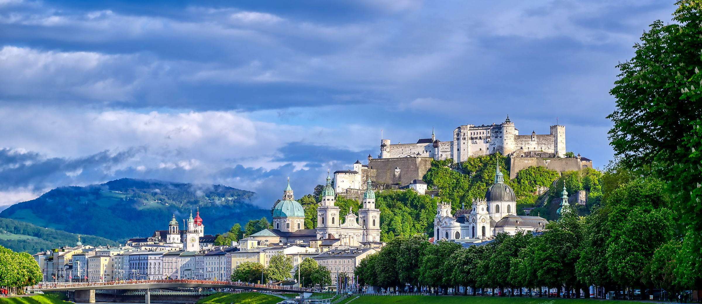 Salzburg under snow with the Hohensalzburg fortress on the ridge above the city